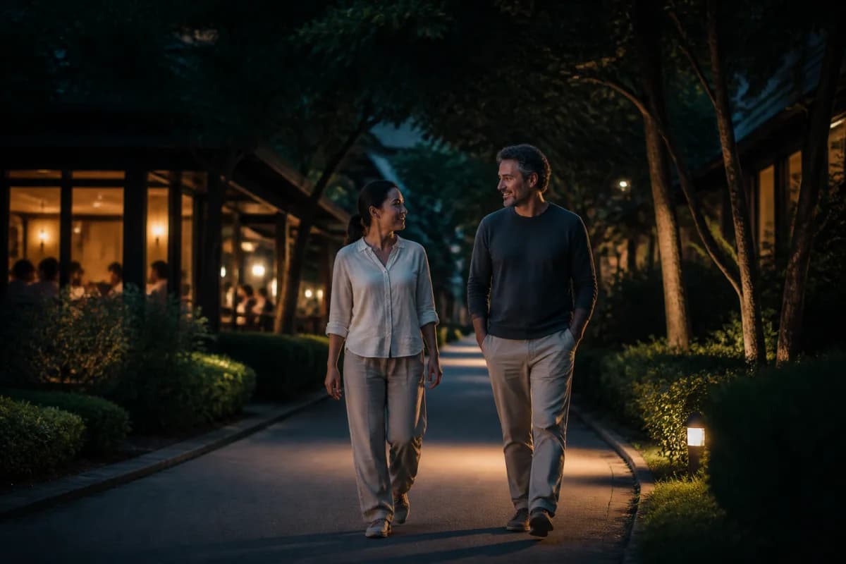 Two adults taking a relaxed walk outdoors after a healthy meal